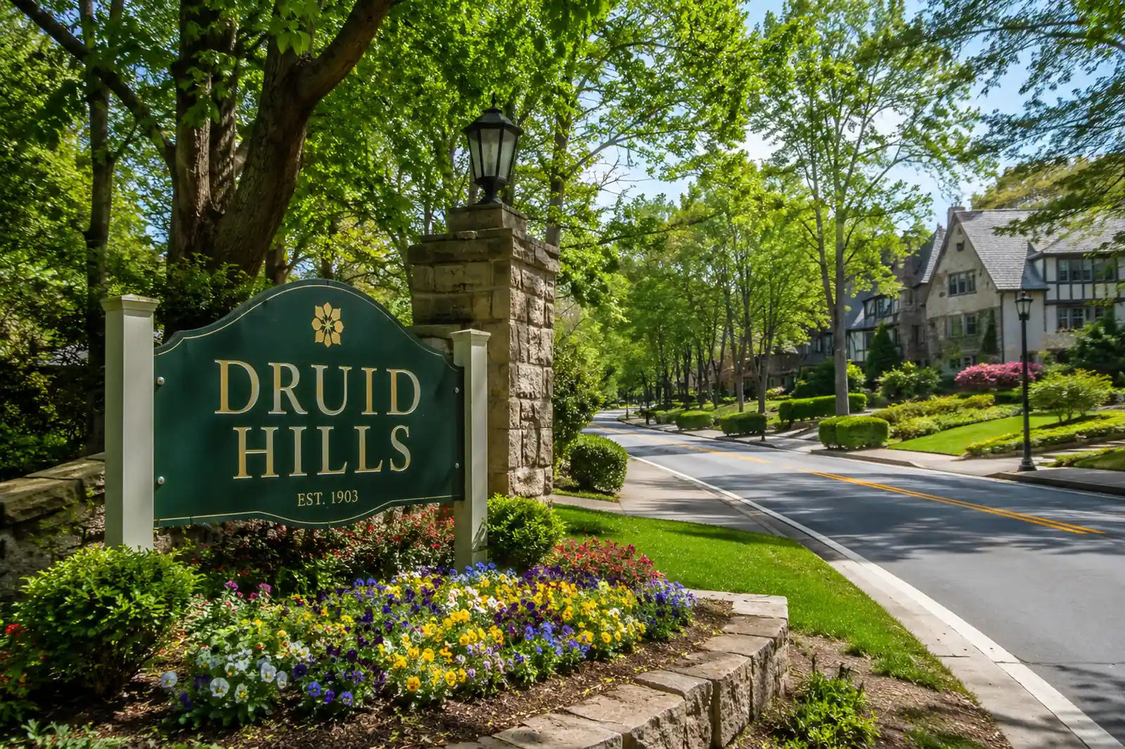Tree-lined residential street in Druid Hills GA with historic homes and landscaped neighborhood entrance