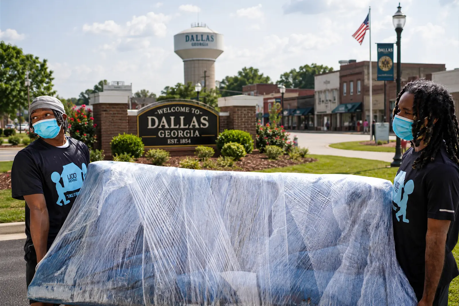 LIOO Moving crew protecting and carrying wrapped furniture during a residential move in Dallas, Georgia