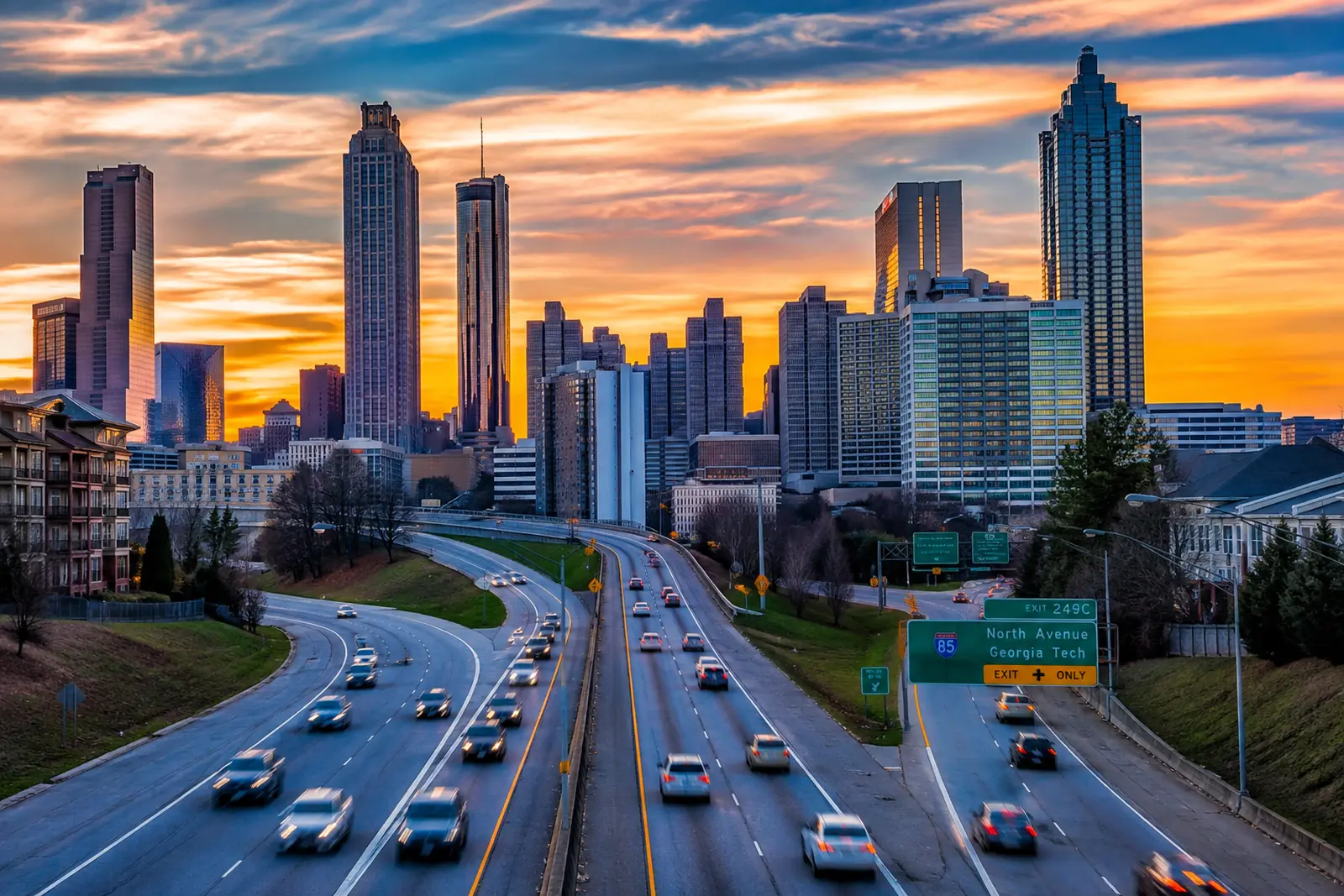 Atlanta skyline overlooking Interstate 85 traffic near the North Avenue exit during sunset.